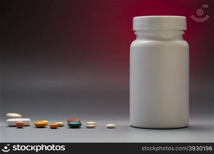 Plastic white medical bottle on a colorful background. Plastic medical bottle with pills on copy space