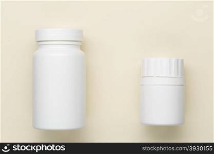 Plastic white medical bottle. Plastic medical bottle on a beige background