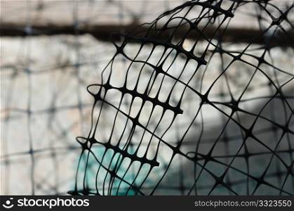 Plastic wire fence used in construction macro. Abstract background.