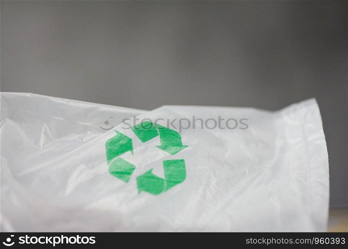 Plastic world or World Environment Day Concept / Green recycle logo in a plastic bag Reduce environmental zero waste concept shopping bag , selective focus