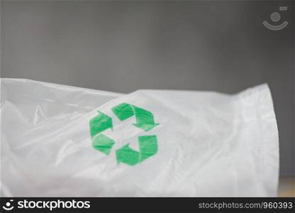 Plastic world or World Environment Day Concept / Green recycle logo in a plastic bag Reduce environmental zero waste concept shopping bag , selective focus