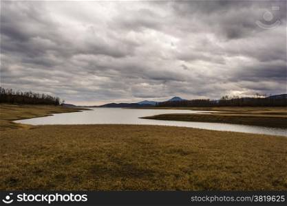 Plastiras lake view with dramatic cloudy sky, in central Greece