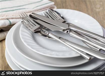 plate and cutlery on a wooden background. plate and cutlery