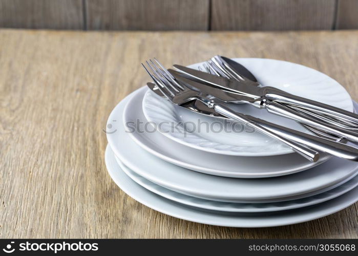 plate and cutlery on a wooden background. plate and cutlery