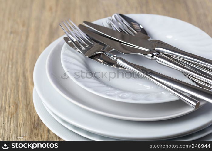 plate and cutlery on a wooden background. plate and cutlery