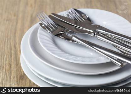 plate and cutlery on a wooden background. plate and cutlery