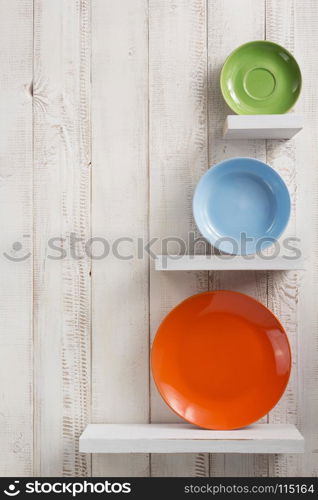 plate at kitchen shelf on white wooden background