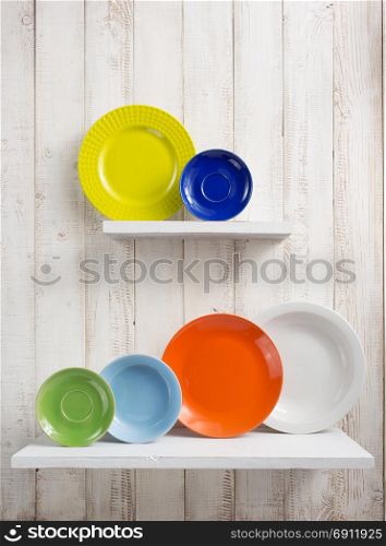 plate at kitchen shelf on white wooden background