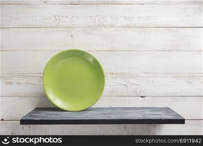 plate at shelf on white wooden background