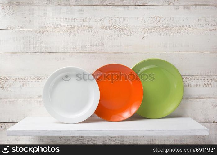 plate at shelf on white wooden plank background
