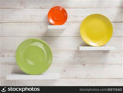 plate at shelves on white wooden plank background