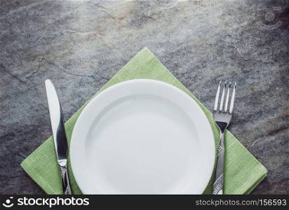 plate, knife and fork on napkin cloth