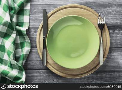plate, knife and fork on rustic background. plate, knife and fork on rustic wooden background