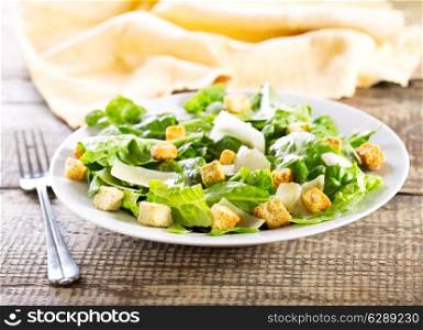 plate of caesar salad on wooden table