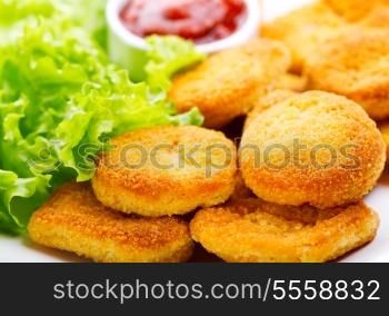 plate of chicken nuggets with salad