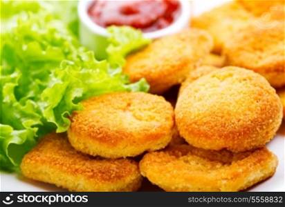 plate of chicken nuggets with salad