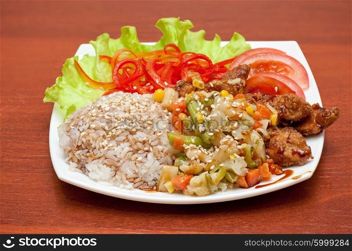 plate of chinese rice with roasted meat and vegetables. rice with roasted meat and vegetables