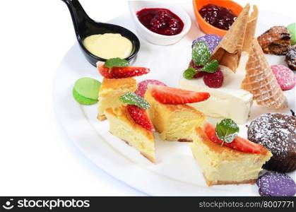 Plate of different desserts isolated on white
