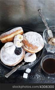 Plate of donuts with coffee and sugar