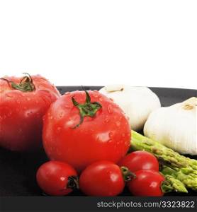 plate of fresh tomatoes ;cherry tomatoes asparagus and garlic ,typical mediterranean food