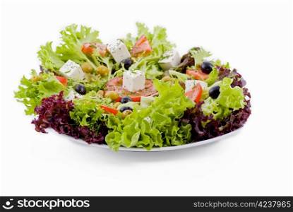 Plate of fresh vegetables - salad, olives, tomato, feta and herbs