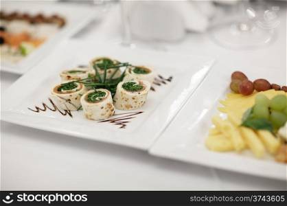 Plate of gourmet appetizers displayed on a table at a restaurant or catered function. Nice shallow depth of field
