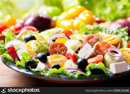 plate of greek salad on wooden table