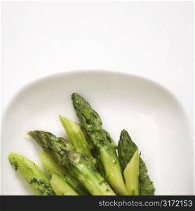 Plate of green cooked asparagus.