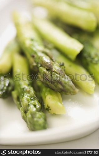 Plate of green cooked asparagus.