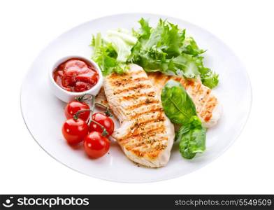 plate of grilled chicken breast with vegetables isolated on white background