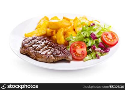plate of grilled meat with vegetables on white background