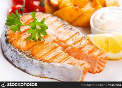 plate of grilled salmon steak with vegetables