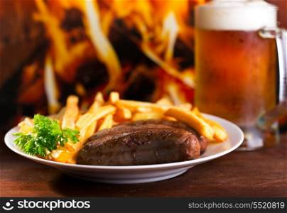 plate of grilled sausages with fries