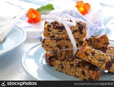 Plate of homemade muesli bars wrapped with a bow.