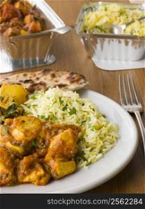 Plate Of Indian Take Away- Chicken Bhoona, Sag Aloo, Pilau Rice And Naan Bread