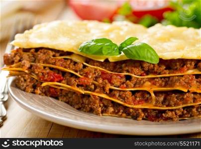 plate of italian lasanga on wooden table