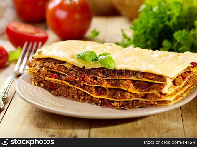 plate of lasagna on wooden table