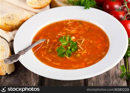 plate of Minestrone Soup on wooden background