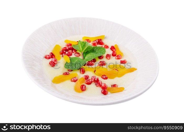 Plate of oatmeal with porridge , dried apricots and pomegranates