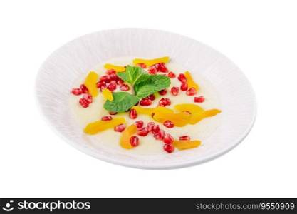 Plate of oatmeal with porridge , dried apricots and pomegranates