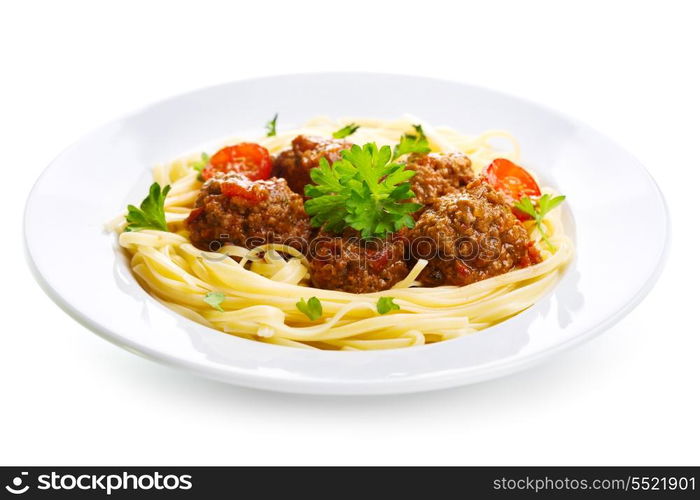 plate of pasta with meatballs on white background