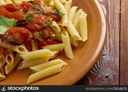 plate of penne rigata pasta with marinara sauce .farm-style