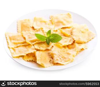 plate of ravioli with basil isolated on white background