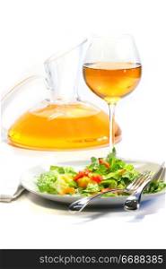 Plate of salad and wine glass on white background