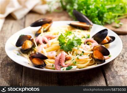 plate of seafood pasta on wooden table