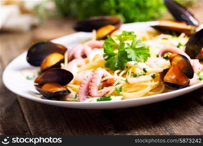 plate of seafood pasta on wooden table
