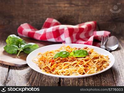 plate of spaghetti bolognese on wooden table