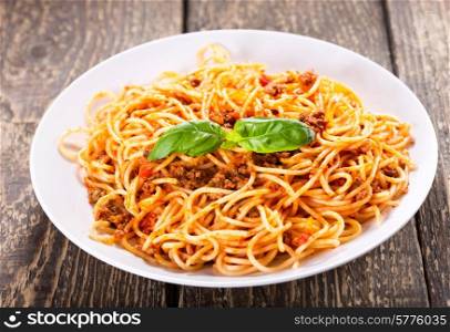 plate of spaghetti bolognese on wooden table
