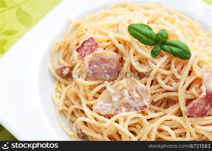 plate of spaghetti carbonara with bacon to homemade basil. -