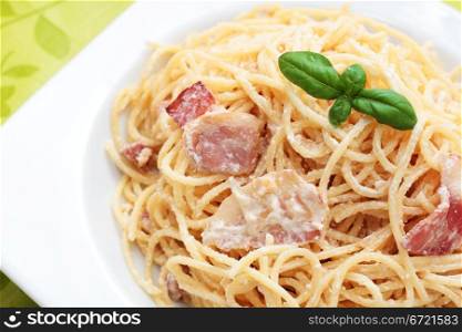plate of spaghetti carbonara with bacon to homemade basil. -